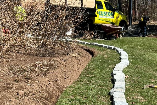 preparing to install paver edging around a garden